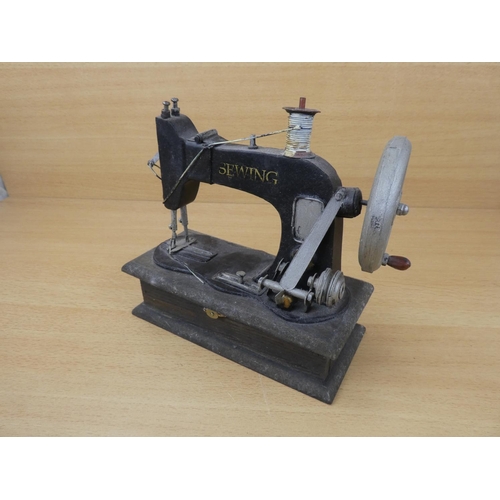 69 - A miniature sewing machine.