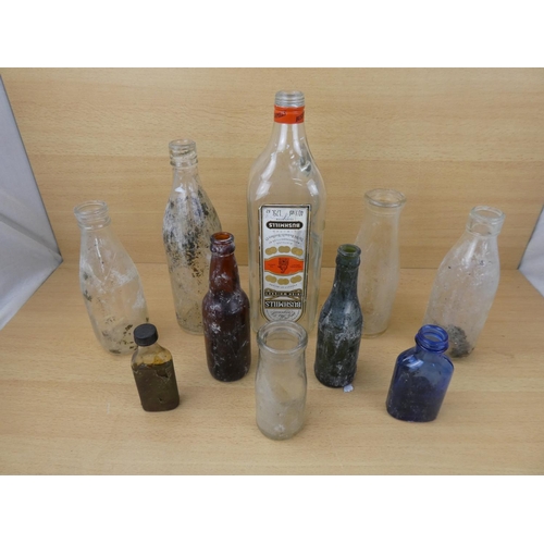 72 - A collection of vintage glass bottles to include a Bushmill's Whiskey 1.75L bottle, a Tyrone Mineral... 