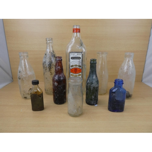 72 - A collection of vintage glass bottles to include a Bushmill's Whiskey 1.75L bottle, a Tyrone Mineral... 