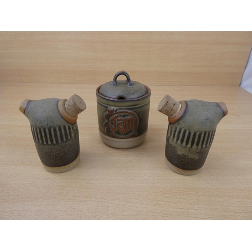 73 - A Tremar stoneware salt and pepper shakers and a lidded jam pot.