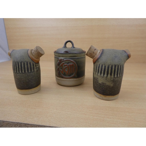 73 - A Tremar stoneware salt and pepper shakers and a lidded jam pot.