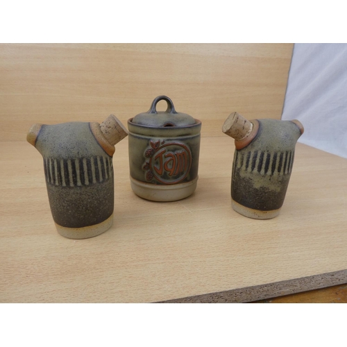 73 - A Tremar stoneware salt and pepper shakers and a lidded jam pot.