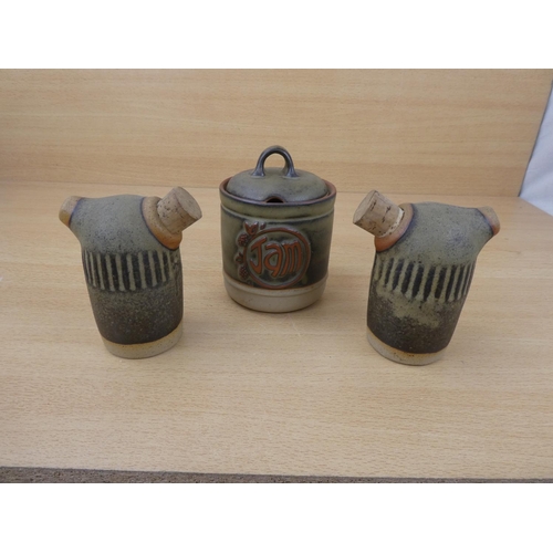 73 - A Tremar stoneware salt and pepper shakers and a lidded jam pot.