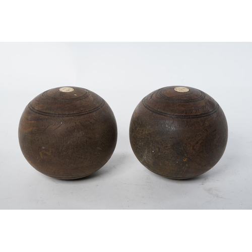 102 - Two wooden turned carpet bowls.