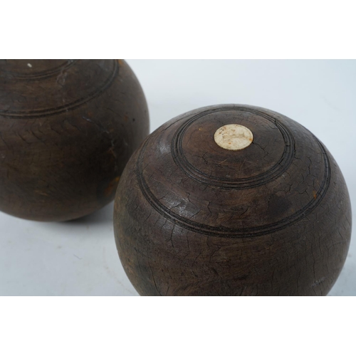 102 - Two wooden turned carpet bowls.