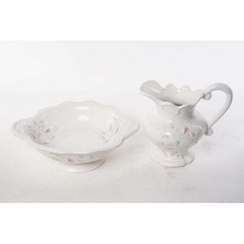 104 - A jug and bowl set with floral design.