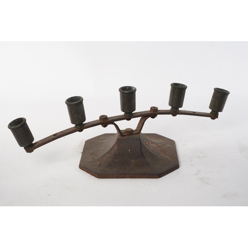 146 - An antique cast iron candleholder.