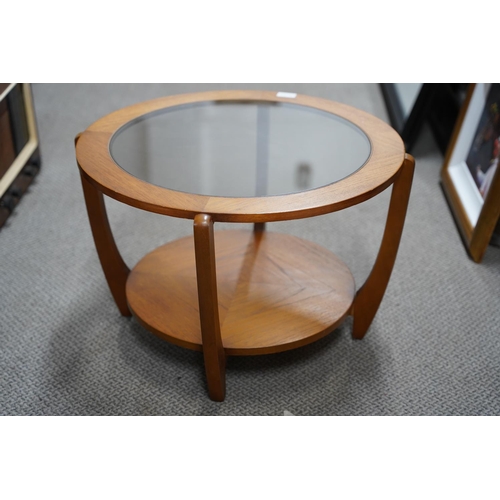 489 - A vintage teak circular coffee table with glass top, measuring 60x40x60cm.