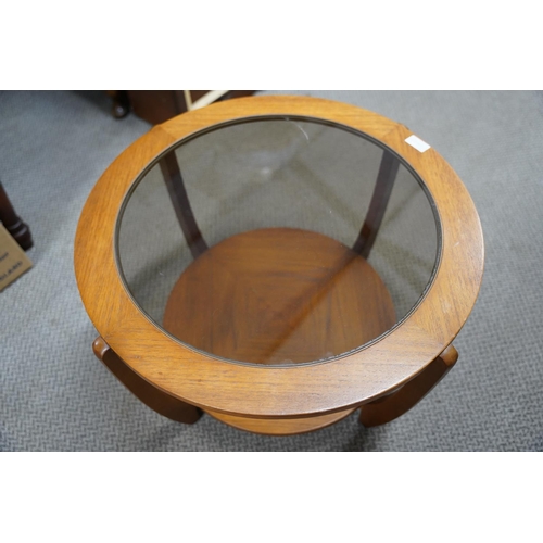 489 - A vintage teak circular coffee table with glass top, measuring 60x40x60cm.