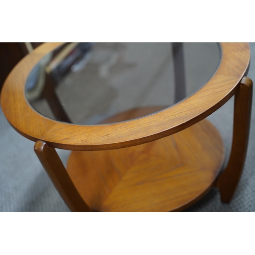 489 - A vintage teak circular coffee table with glass top, measuring 60x40x60cm.