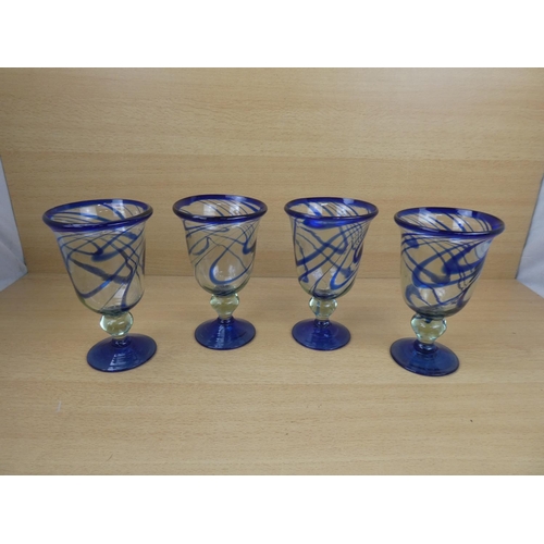 503 - A set of four large blue glass goblets.