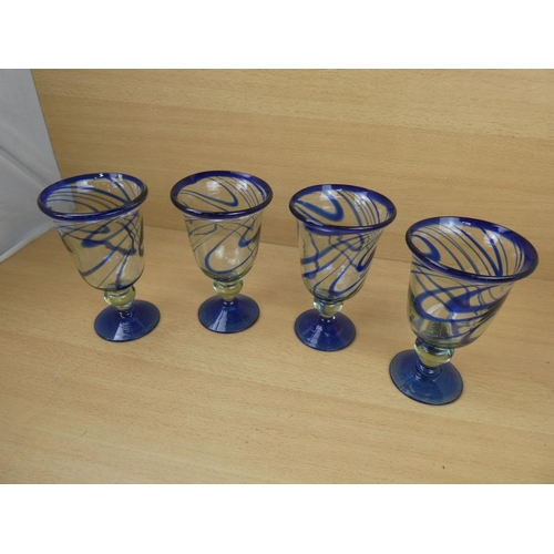 503 - A set of four large blue glass goblets.