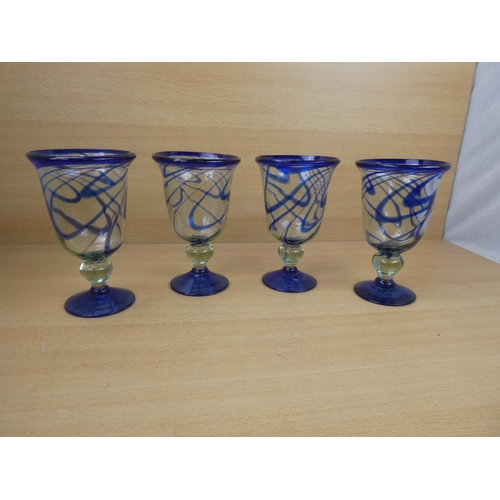 503 - A set of four large blue glass goblets.