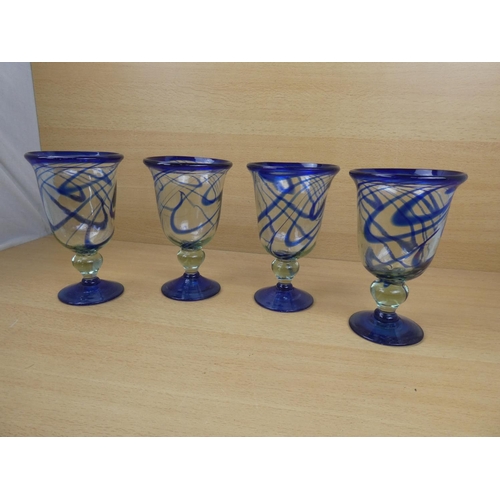 503 - A set of four large blue glass goblets.