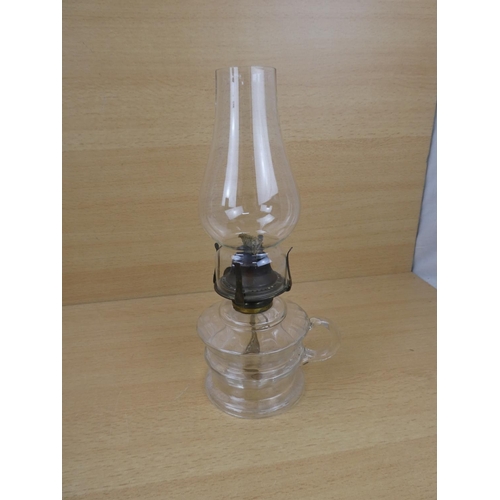 504 - A vintage clear glass finger lamp.