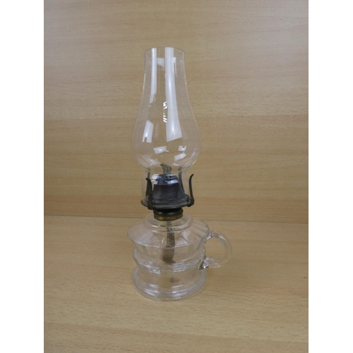 504 - A vintage clear glass finger lamp.