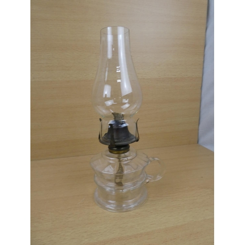 504 - A vintage clear glass finger lamp.