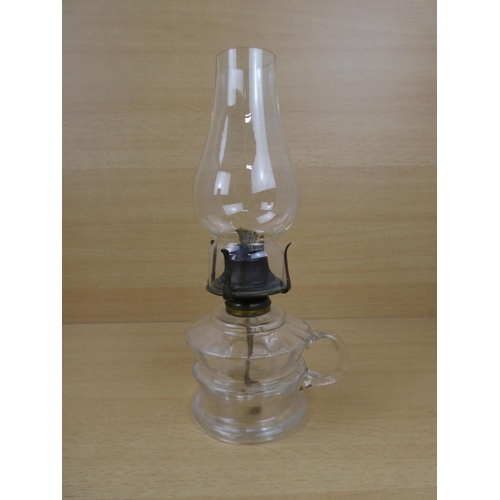 504 - A vintage clear glass finger lamp.