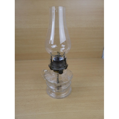 504 - A vintage clear glass finger lamp.