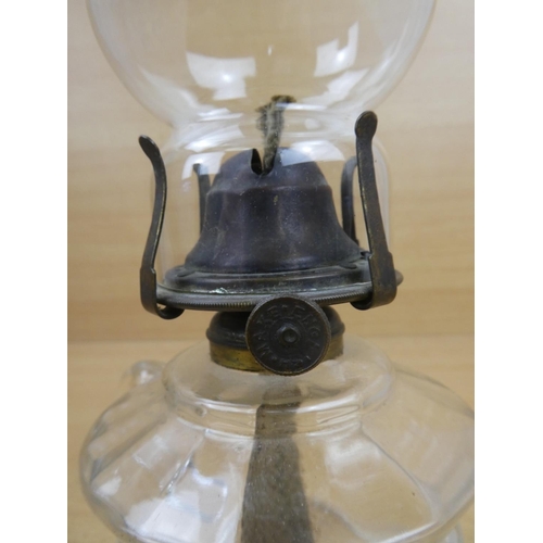 504 - A vintage clear glass finger lamp.