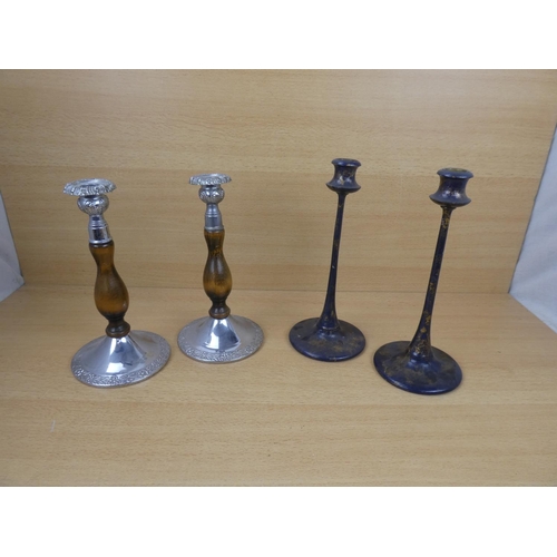 523 - A pair of metal and wood turned candlesticks and another pair.