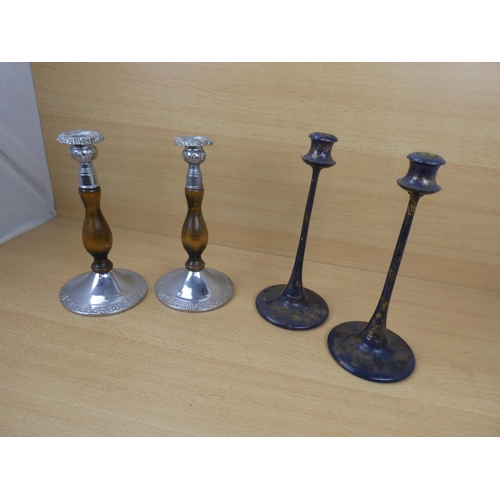 523 - A pair of metal and wood turned candlesticks and another pair.