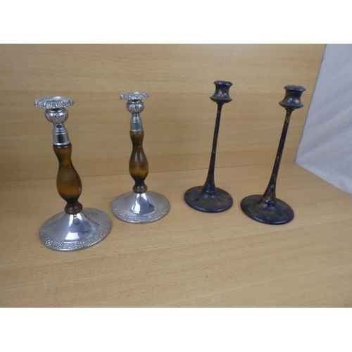 523 - A pair of metal and wood turned candlesticks and another pair.