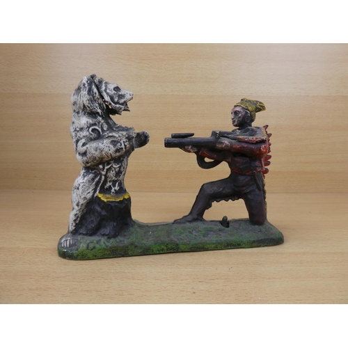 530 - A stunning antique cast iron mechanical money box, modelled as an Indian shooting a white bear. (a/f... 