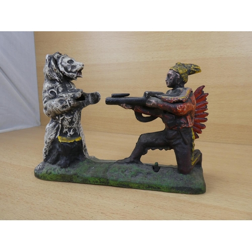 530 - A stunning antique cast iron mechanical money box, modelled as an Indian shooting a white bear. (a/f... 