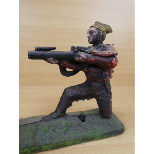 530 - A stunning antique cast iron mechanical money box, modelled as an Indian shooting a white bear. (a/f... 