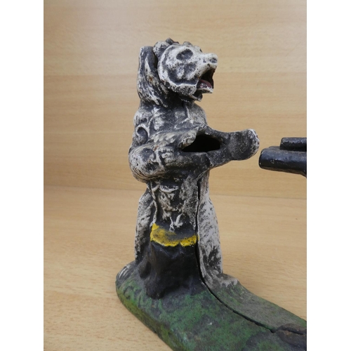 530 - A stunning antique cast iron mechanical money box, modelled as an Indian shooting a white bear. (a/f... 