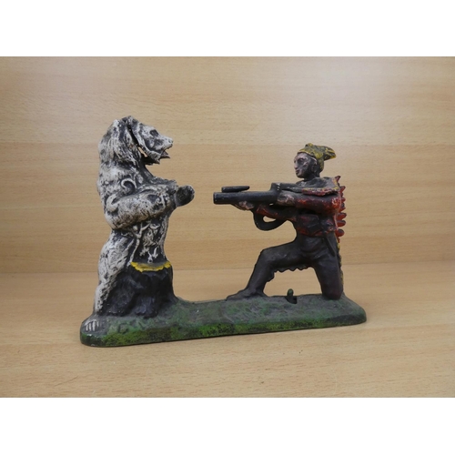 530 - A stunning antique cast iron mechanical money box, modelled as an Indian shooting a white bear. (a/f... 