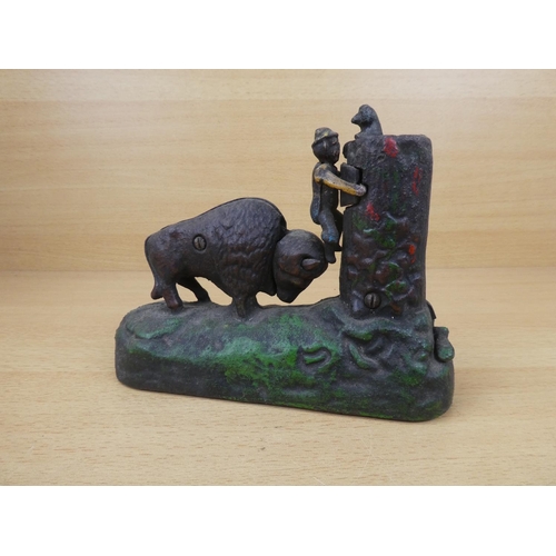 531 - A stunning antique cast iron mechanical money box, modelled as a Buffalo chasing a boy up a tree. 'R... 