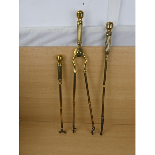 548 - A set of three antique brass fire irons.