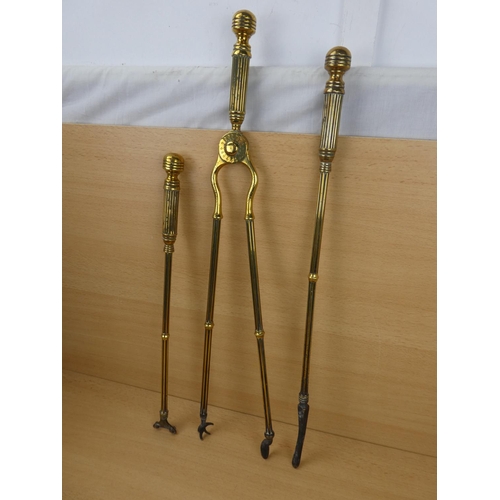 548 - A set of three antique brass fire irons.