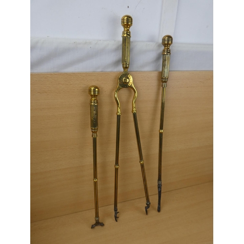 548 - A set of three antique brass fire irons.