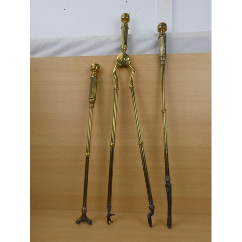 548 - A set of three antique brass fire irons.