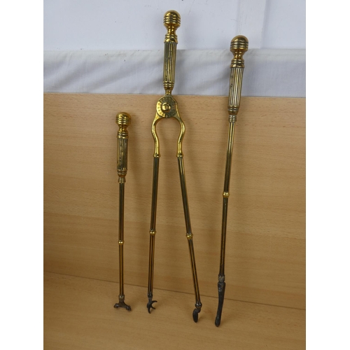 548 - A set of three antique brass fire irons.