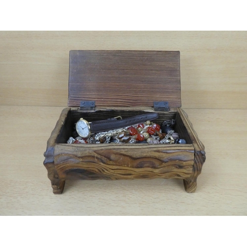 550 - A wooden jewellery chest and contents.