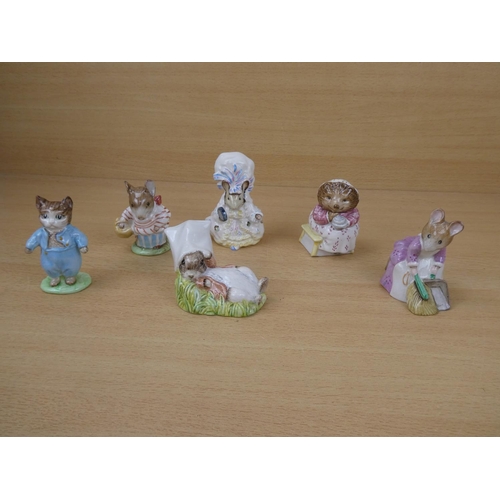 551 - A collection of six Beswick Beatrix Potter ornaments to include Mrs Tittlemouse, Hunca Munca Sweepin... 