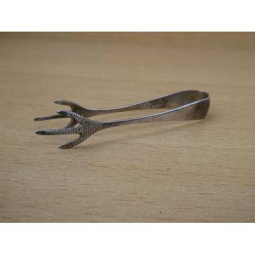 554 - A pair of Sterling Silver sugar nips with claw feet.