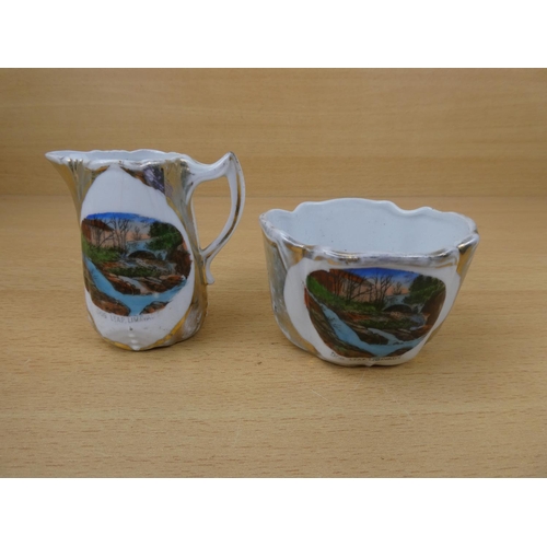 558 - A vintage souvenir jug and bowl 'Dog Leap, Limavady'.