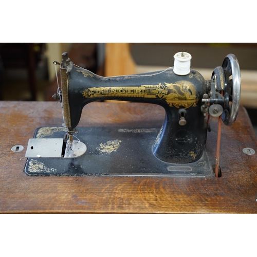 107 - An antique Singer Sewing machine table, measuring 76x98x41cm.