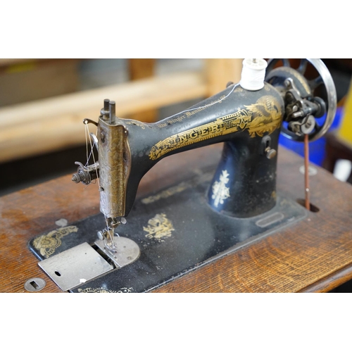 107 - An antique Singer Sewing machine table, measuring 76x98x41cm.