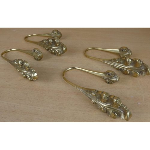 16 - Four brass curtain wall brackets.