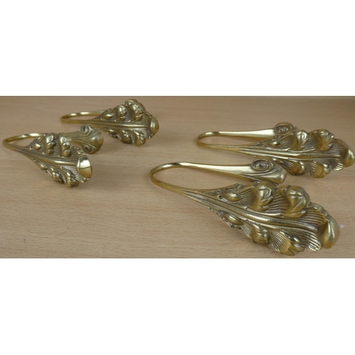 16 - Four brass curtain wall brackets.