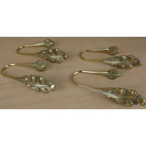 16 - Four brass curtain wall brackets.