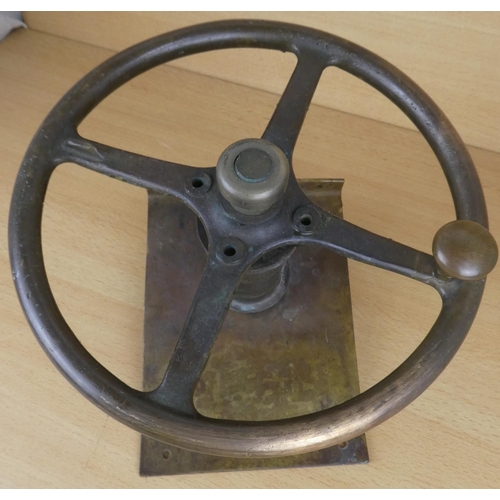 43 - An antique brass wheel of a boat.