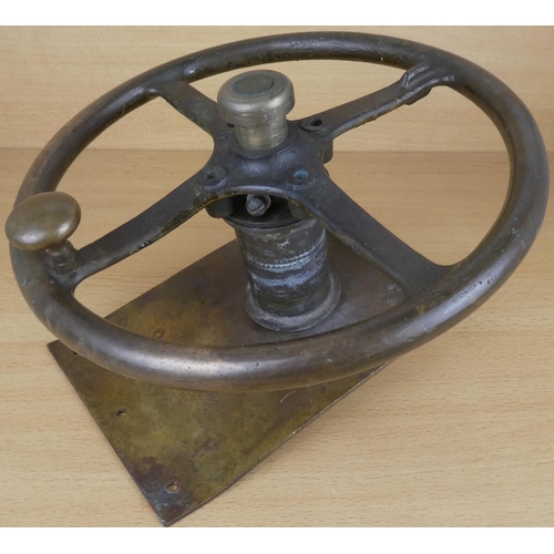 43 - An antique brass wheel of a boat.