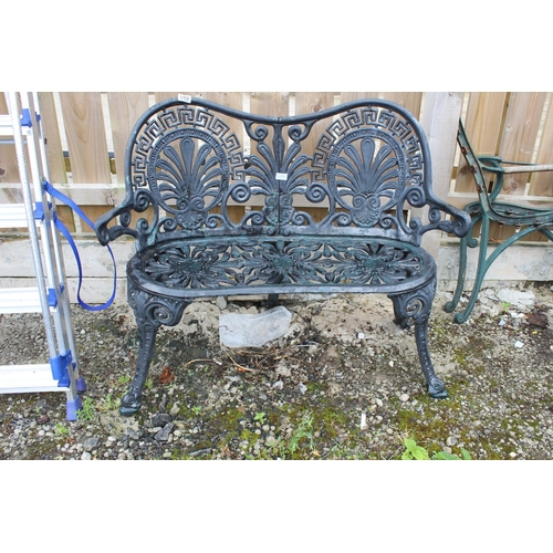 559 - A decorative cast metal garden bench.